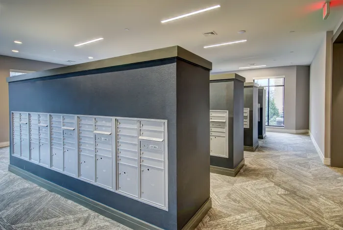 Modern apartment mailroom with sleek mailboxes and stylish lighting, offering a secure and convenient postal solution.