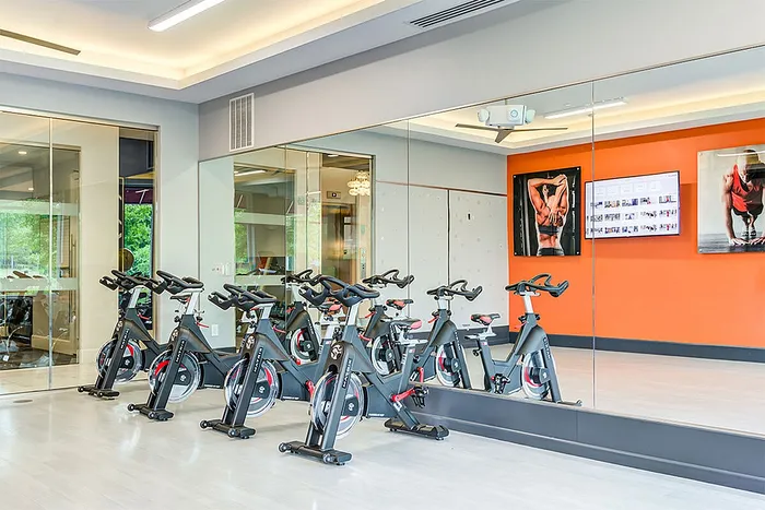 Modern fitness studio with stylish spin bikes, mirrored walls, and vibrant decor, ideal for an energizing workout experience.