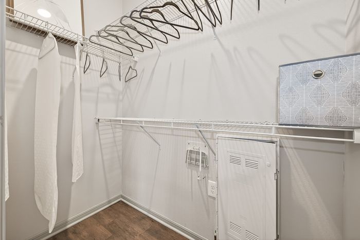 Spacious walk-in closet with sleek wire shelving and ample storage space.