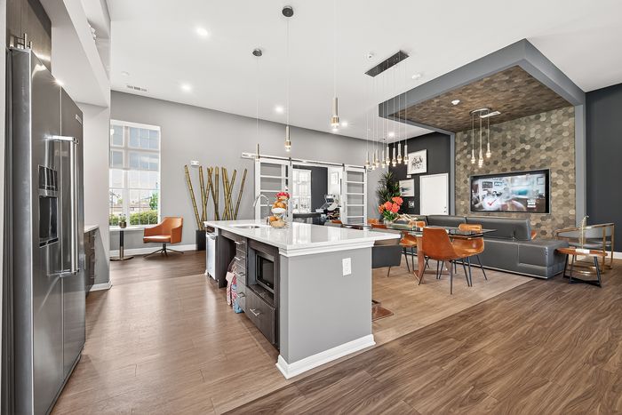 Sleek modern kitchen with spacious island, elegant lighting, and stylish open-concept living area.