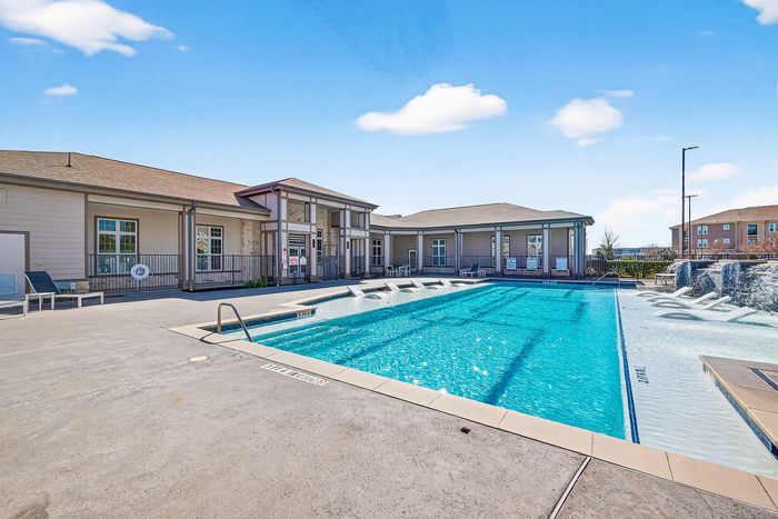 Inviting apartment complex with a stunning outdoor pool and modern clubhouse, perfect for relaxation and social gatherings.