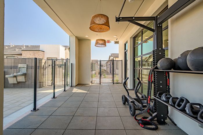 Sleek outdoor fitness area with modern equipment and stylish lighting, perfect for invigorating workouts.