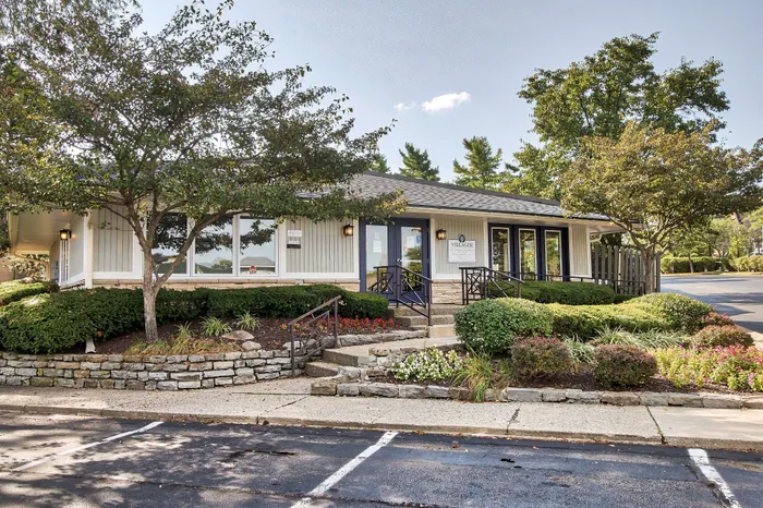 Charming apartment building facade with lush landscaping and inviting entrance, ideal for welcoming residents.
