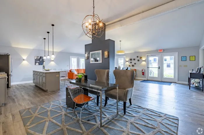 Modern and inviting open-concept living space with elegant lighting, stylish furnishings, and expansive windows offering natural light.
