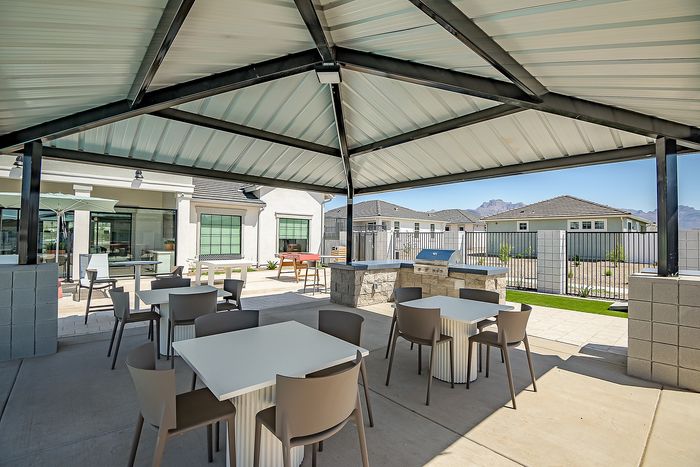 Spacious outdoor patio area with modern seating, shaded cover, and scenic mountain views, perfect for entertaining and relaxation.