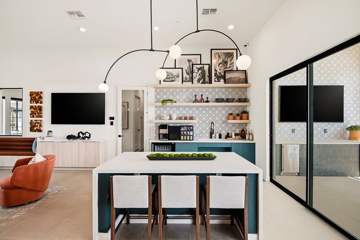 Modern living area with stylish kitchen, featuring sleek cabinetry, elegant lighting, and comfortable seating; perfect blend of functionality and contemporary design.
