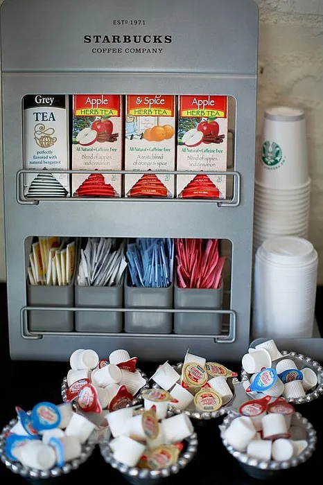 Inviting Starbucks tea selection display with assorted herbal teas, sweeteners, and creamers in a stylish setup.