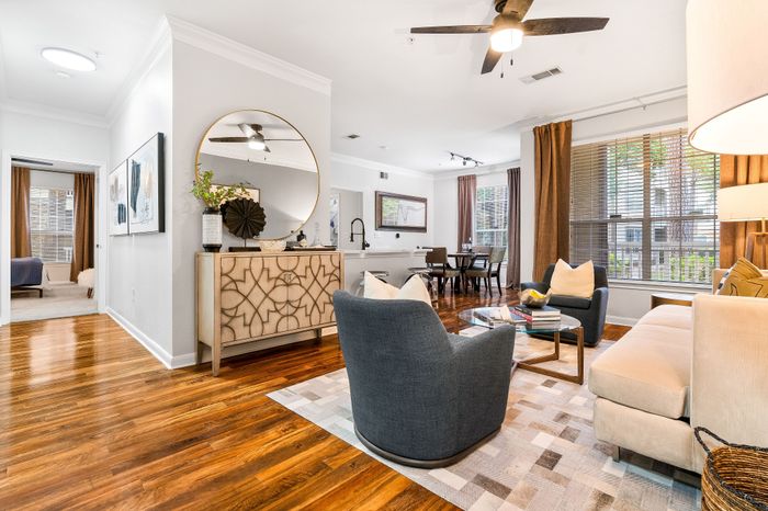 Bright, modern living area with hardwood floors, elegant decor, and cozy seating.
