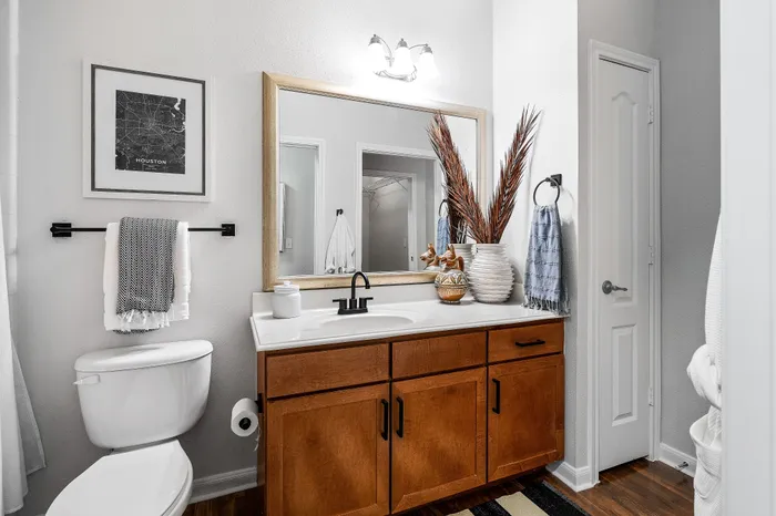 Elegantly designed bathroom with modern wooden cabinetry, a stylish countertop, and decorative accents for a refreshing touch.