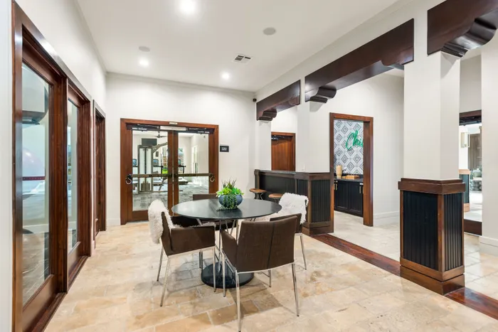 Elegant communal area with a modern round table, plush chairs, and contemporary decor, offering a welcoming and vibrant atmosphere.