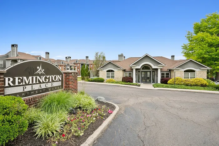 Inviting entrance of Remington Place Apartment Homes with manicured landscaping and classic architectural design.