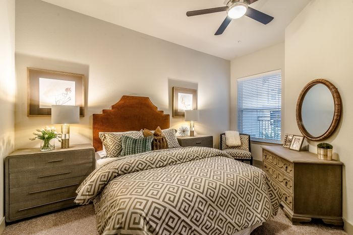 Cozy bedroom with elegant decor, featuring a plush bed, stylish nightstands, and warm lighting for a serene ambiance.