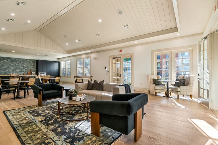 Bright and inviting living area with elegant seating, stylish decor, and abundant natural light from large windows.