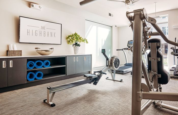Modern fitness center at The Highbank featuring state-of-the-art cardio equipment, sleek design, and vibrant workout accents.