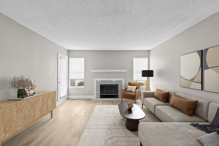 Elegant living room with modern decor, featuring a cozy sofa, stylish coffee table, and a classic fireplace.