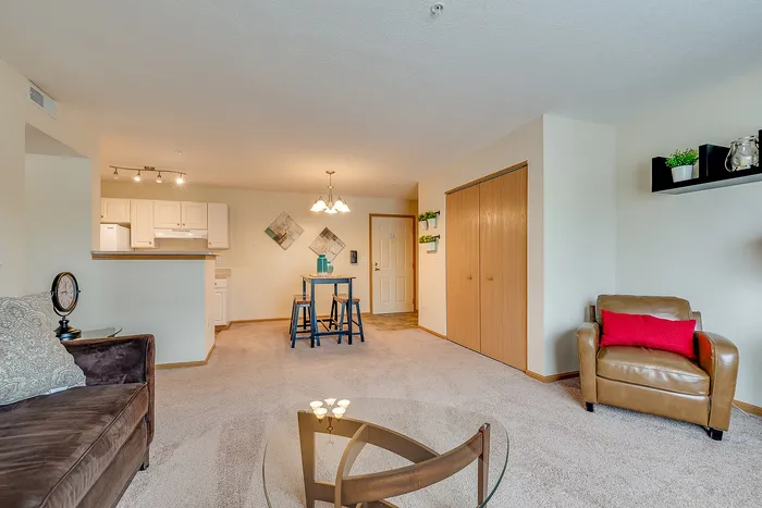 Inviting living room with plush seating, elegant decor, and a cozy dining area, complemented by a modern kitchen and warm lighting.