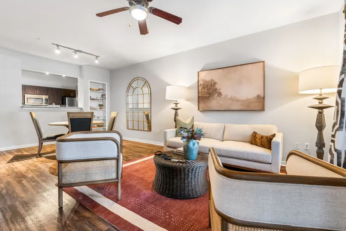 Elegant open-concept living room with cozy seating, stylish decor, and modern dining area, perfect for relaxation and entertaining.