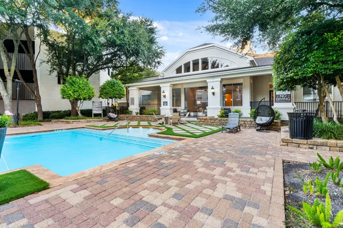 Inviting outdoor pool area with stylish loungers and lush greenery, perfect for relaxation and gatherings.