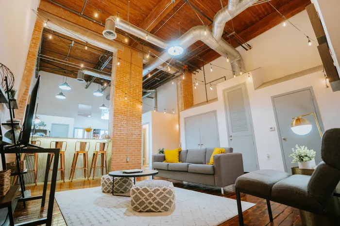 Stylish loft apartment with exposed brick, modern furniture, and industrial lighting