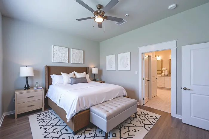 Inviting bedroom with a luxurious bed, tasteful decor, and seamless access to a modern bathroom.