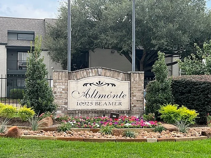 Inviting entrance to Altmonte Apartments with lush landscaping and welcoming signage at 10925 Beamer.