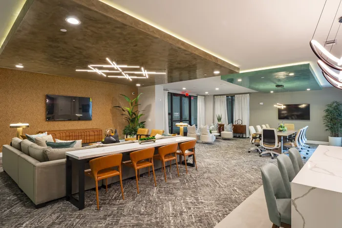 Luxurious modern living area with elegant lighting, cozy seating, and a stylish open-concept office space.