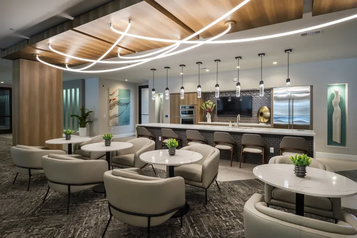 Contemporary lounge area with elegant seating, chic lighting, and a stylish bar, perfect for social gatherings.