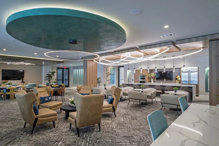 Luxurious modern lounge area featuring elegant seating, stylish decor, and ambient lighting, perfect for social gatherings and relaxation.