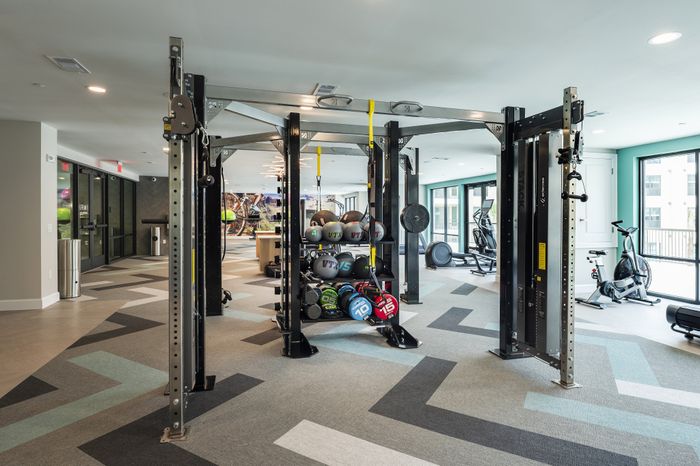 Modern fitness center with state-of-the-art exercise equipment, ample lighting, and vibrant decor.
