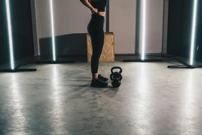 Dynamic fitness space featuring a kettlebell workout setup with modern lighting and motivational vibes.