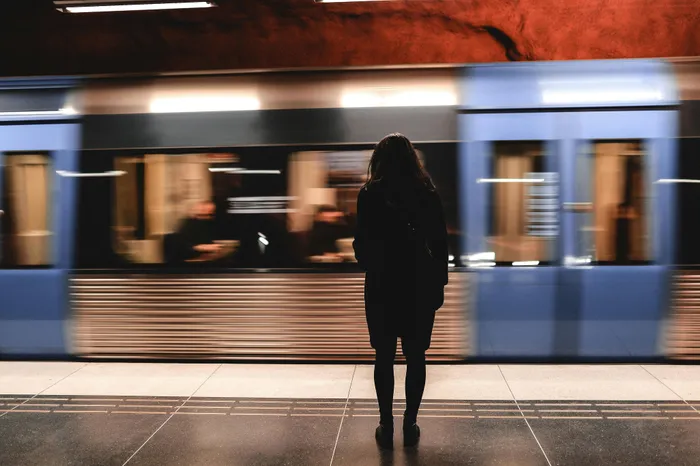 Dynamic city life captured with a stylish subway platform scene and speeding train, ideal for urban living enthusiasts.
