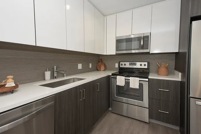 Modern kitchen with sleek stainless steel appliances, elegant cabinetry, and a stylish minimalist design.