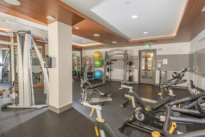 Modern fitness center equipped with state-of-the-art exercise machines and vibrant workout area.