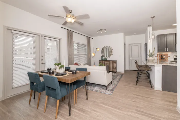 Chic open-plan apartment with bright living room, elegant dining area, modern kitchen, and stylish decor.