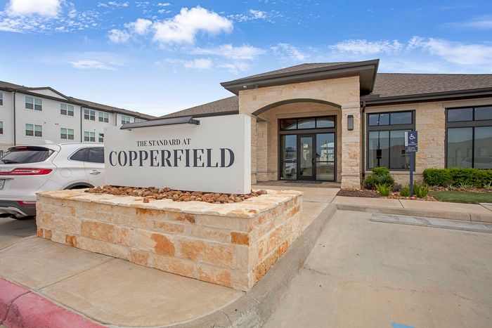Welcoming exterior of The Standard at Copperfield featuring modern architecture and a spacious parking area.