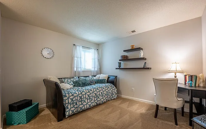Cozy bedroom with neutral decor at Scandia Apartments