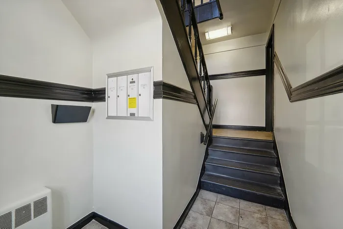 Inviting apartment stairwell with modern design and mailboxes.