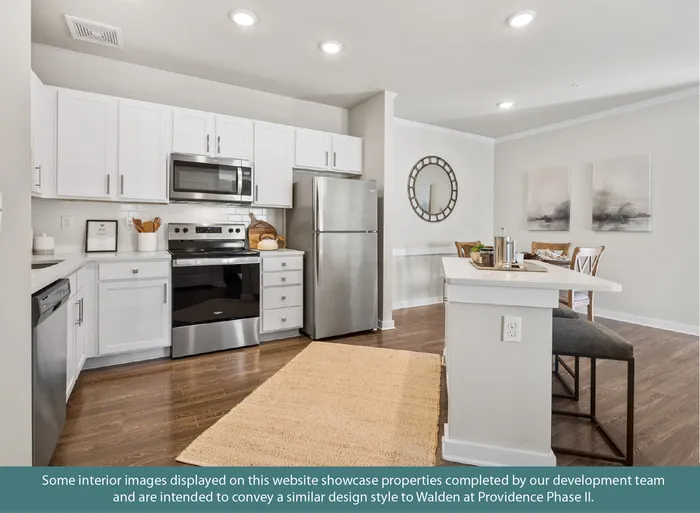 Modern kitchen and dining area featuring stainless steel appliances, elegant white cabinetry, and cozy seating, perfect for family gatherings.