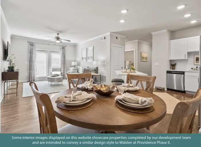 Inviting open-concept living space with elegant dining area, modern kitchen, and cozy seating near large windows.