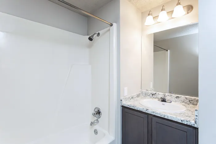 Modern kitchen with sleek granite countertops, elegant cabinetry, and bar seating, offering a perfect blend of style and functionality.