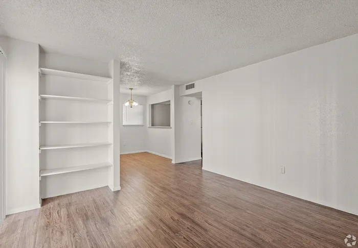 A living room with custom shelving at Fox Trail Apartments