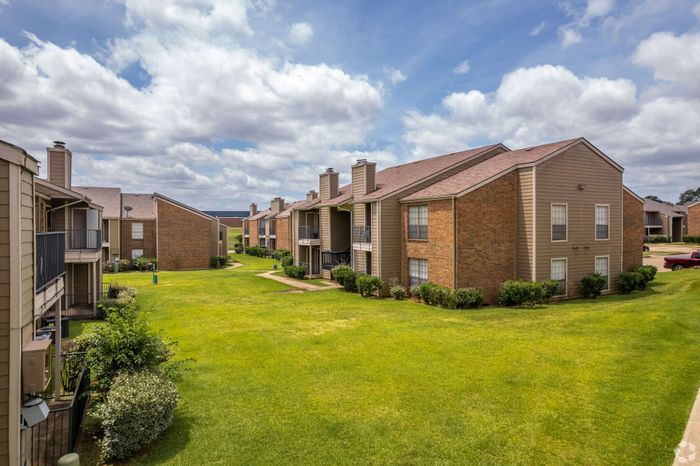 grassy area in between apartment buildings