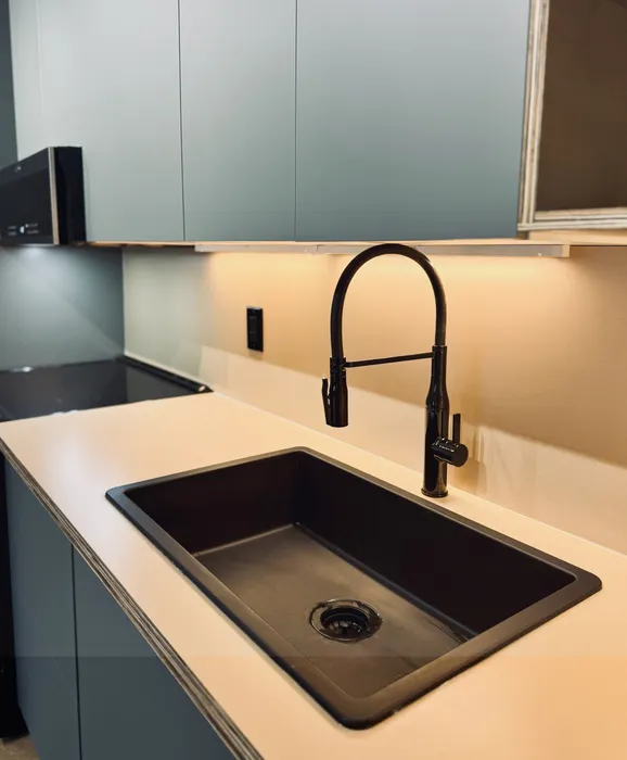 New! 2BD, 1BA - 800SF Premium Plus Available 4/6! Sleek modern kitchen with elegant black sink and stylish cabinetry, creating a contemporary ambiance.