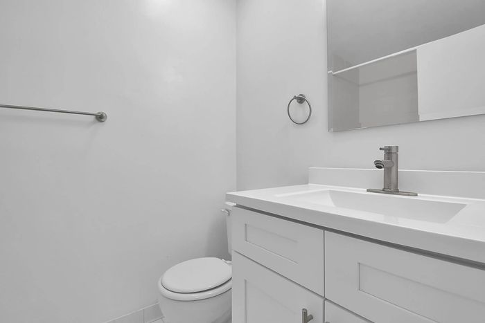 Sleek and modern bathroom with elegant vanity, contemporary fixtures, and minimalist design.
