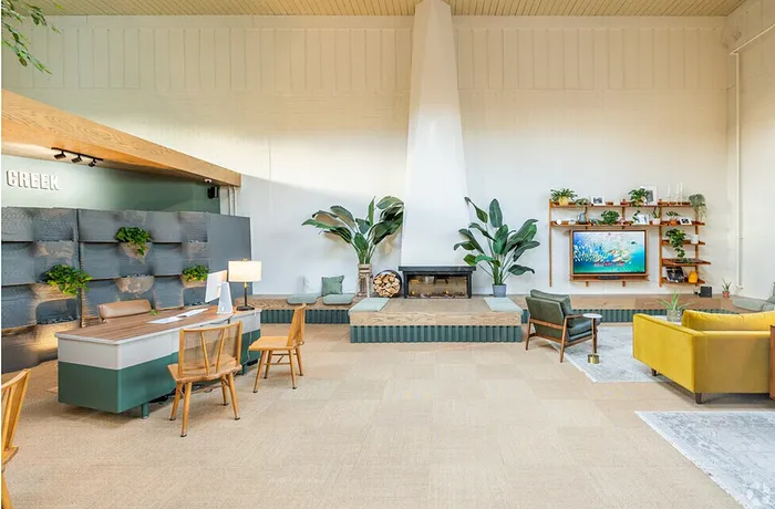 Inviting living area with modern decor, vibrant greenery, and a sleek fireplace, showcasing a perfect blend of comfort and style.