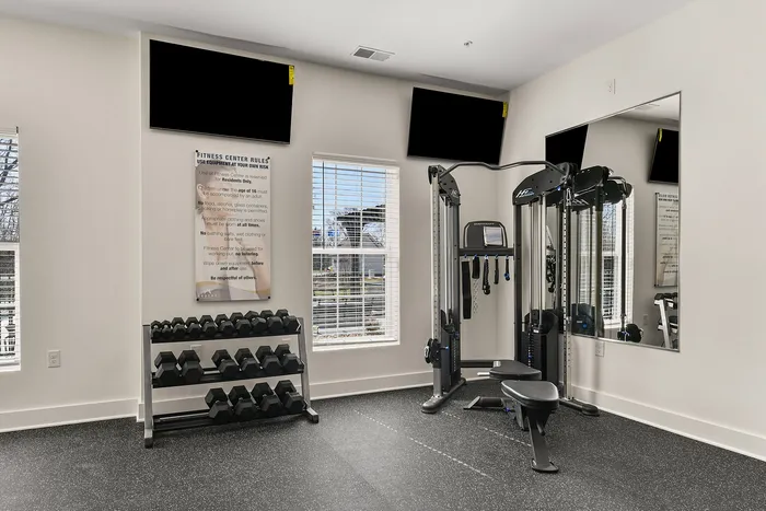 Modern fitness center with state-of-the-art equipment, vibrant natural light, and sleek design for an optimal workout experience.