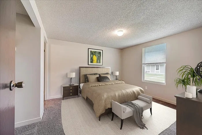 Cozy and inviting bedroom with elegant decor, featuring a plush bed and stylish nightstands in a sunlit space.