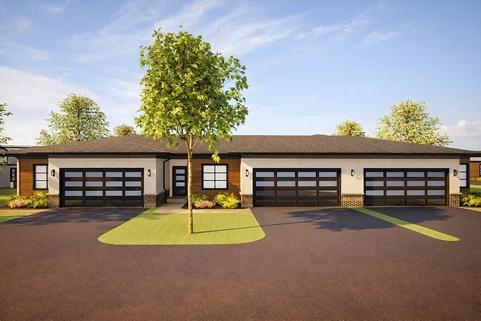 Modern duplex exterior with sleek garage doors, lush landscaping, and inviting curb appeal under a clear blue sky.