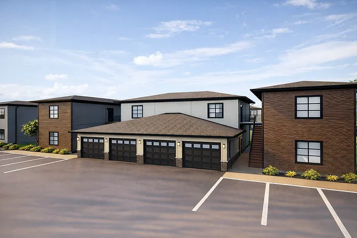 Modern apartment complex with stylish exterior, featuring multiple garage spaces and well-maintained landscaping.