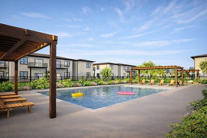 Inviting outdoor pool area with sun loungers and lush landscaping, offering scenic views of modern apartment buildings.